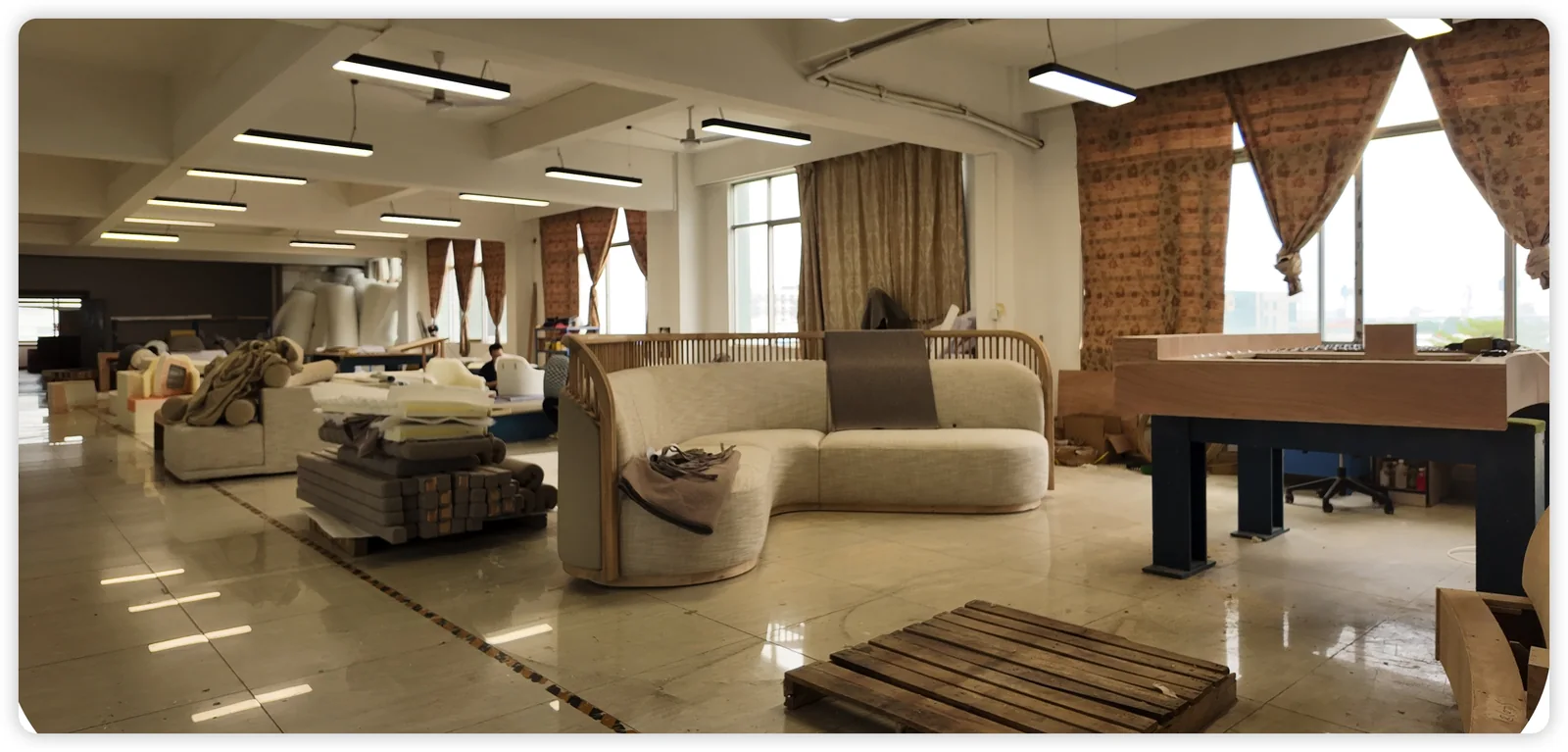 Upholstered furniture and components at different stages of production in a workshop