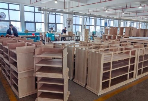 Unfinished wooden cabinets arranged in a production workshop