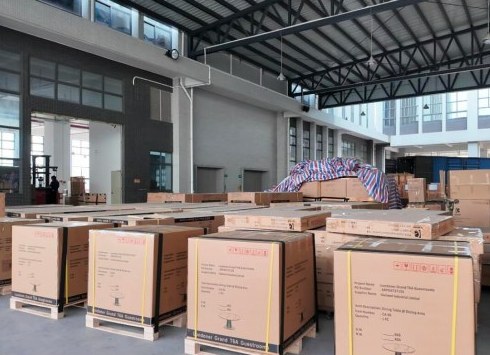 Labelled cartons on pallets inside a furniture warehouse