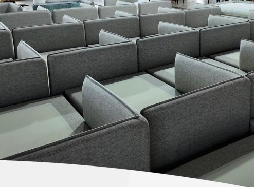 Multiple upholstered sofa units arranged during production