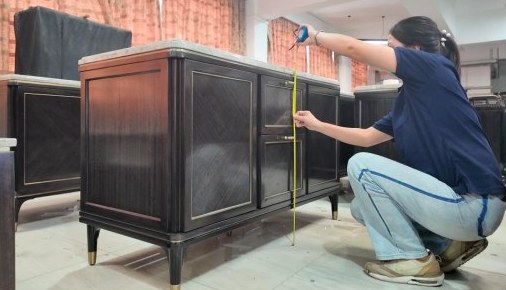 A cabinet being measured during a furniture inspection