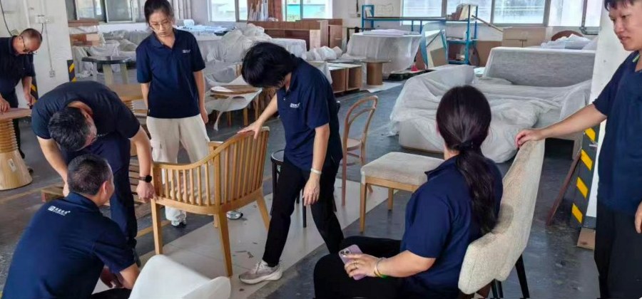 Upholstered chairs being examined for construction and finish details