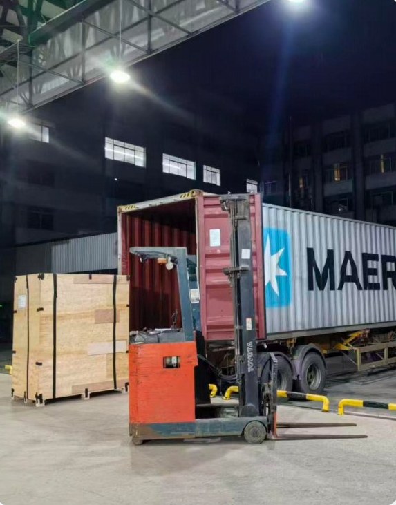 Crates being loaded into a shipping container