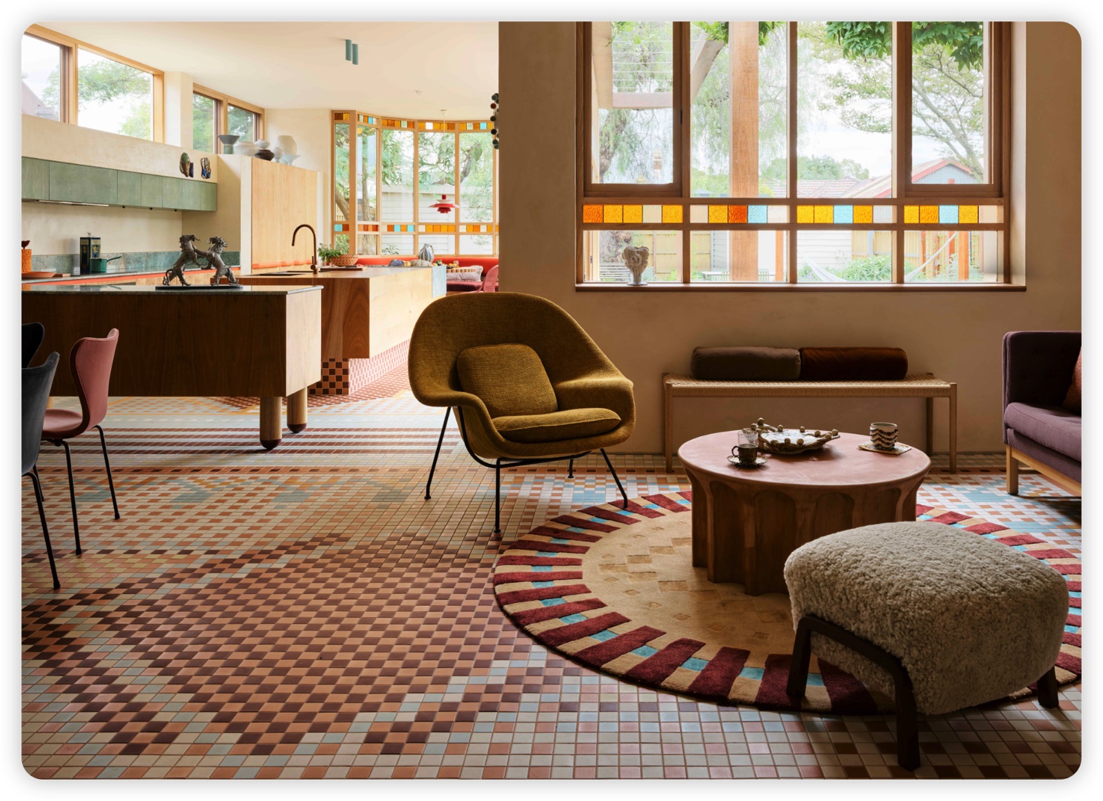 Colorful open-plan living room and kitchen furnished as one complete residential package