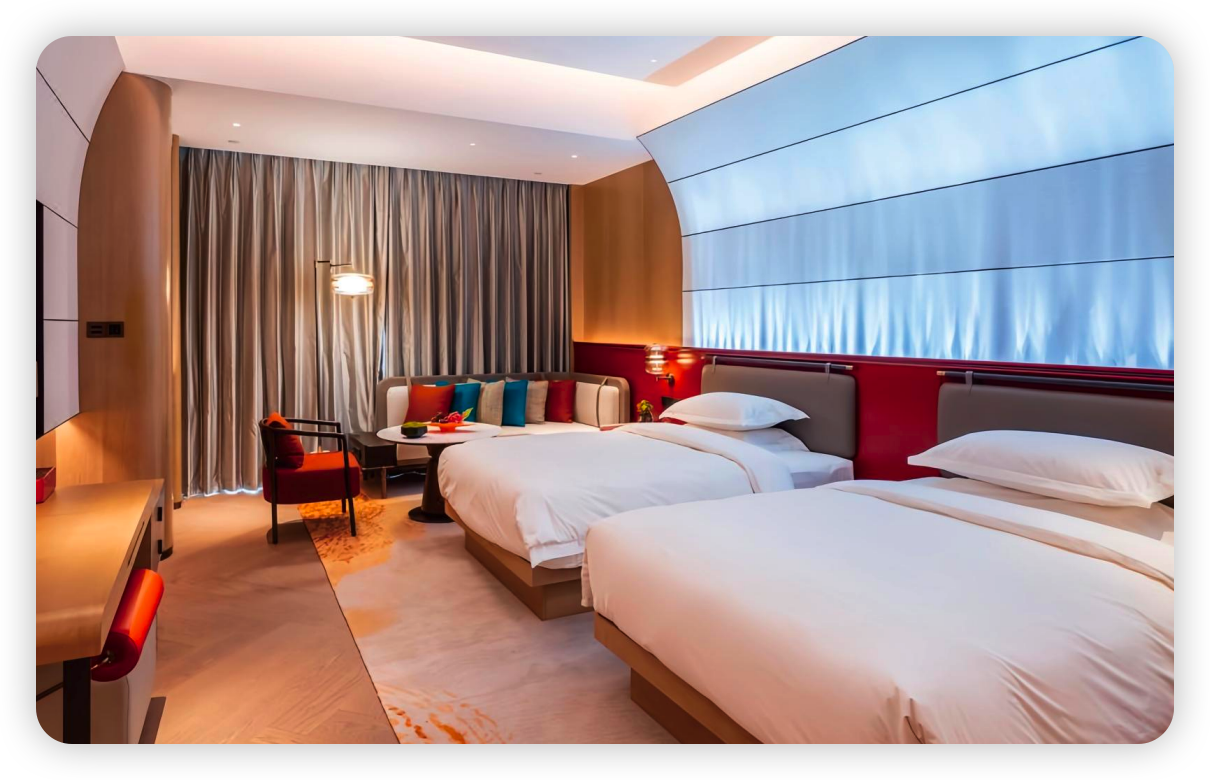 Hotel guestroom with twin beds and integrated seating