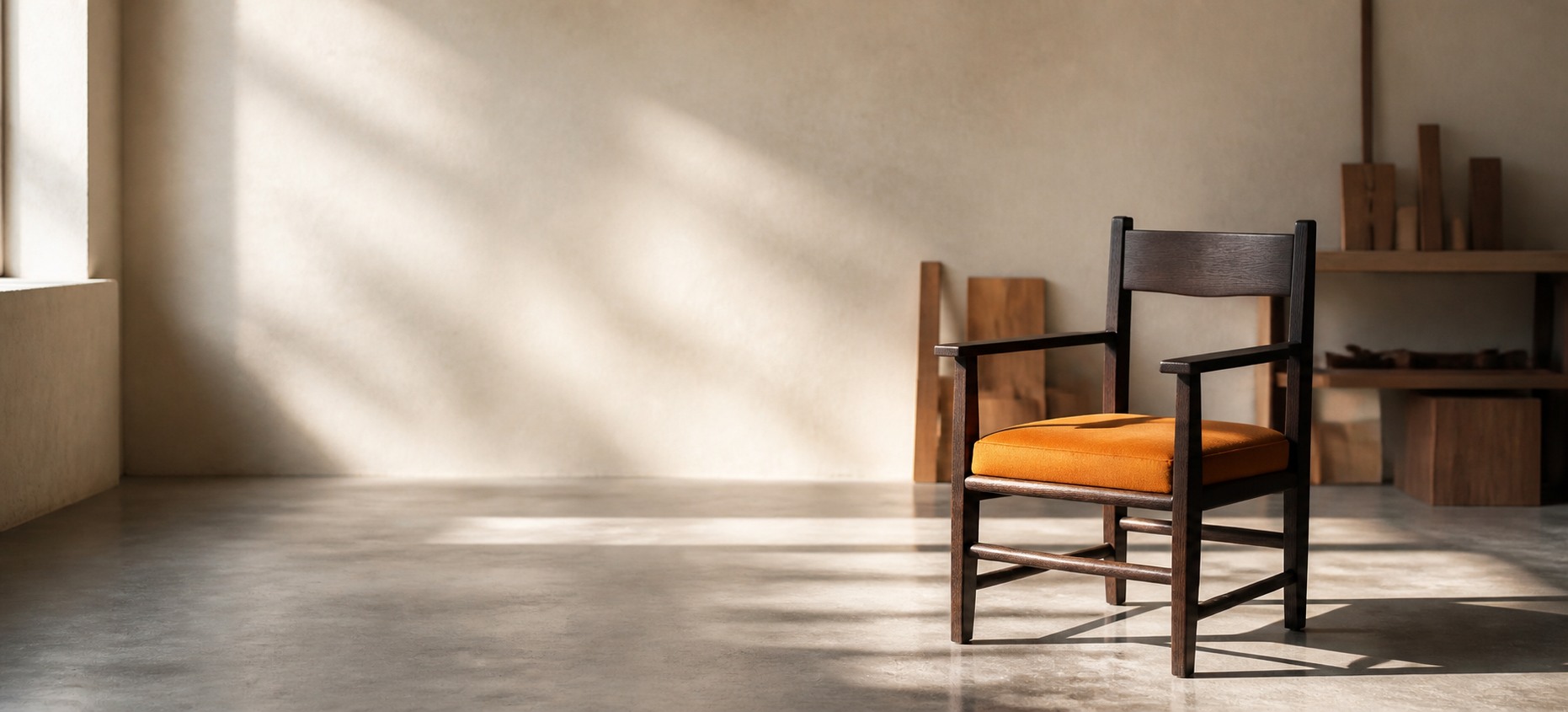 Walnut armchair in a sunlit manufacturing studio