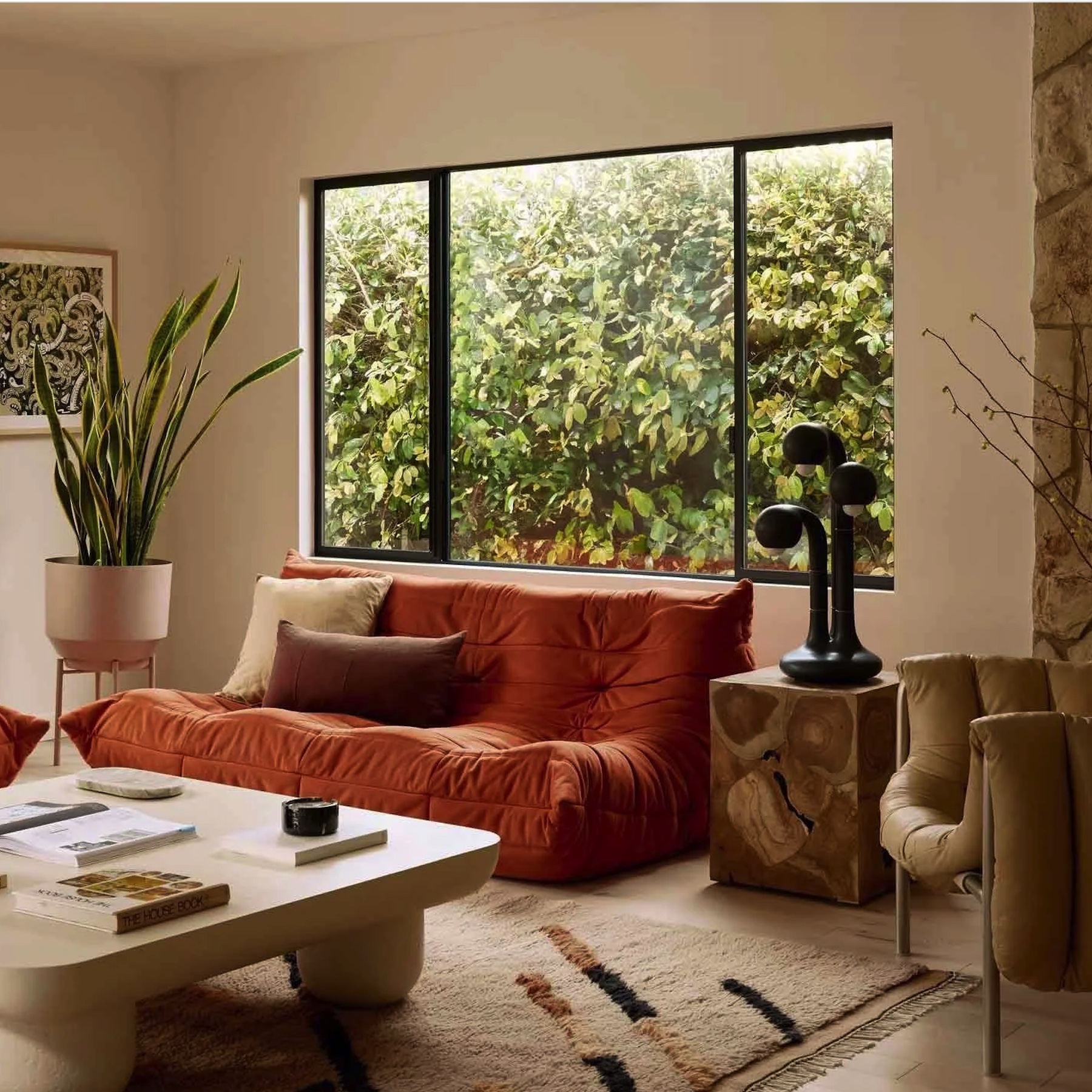 Complete-home interior with sculptural seating and natural stone