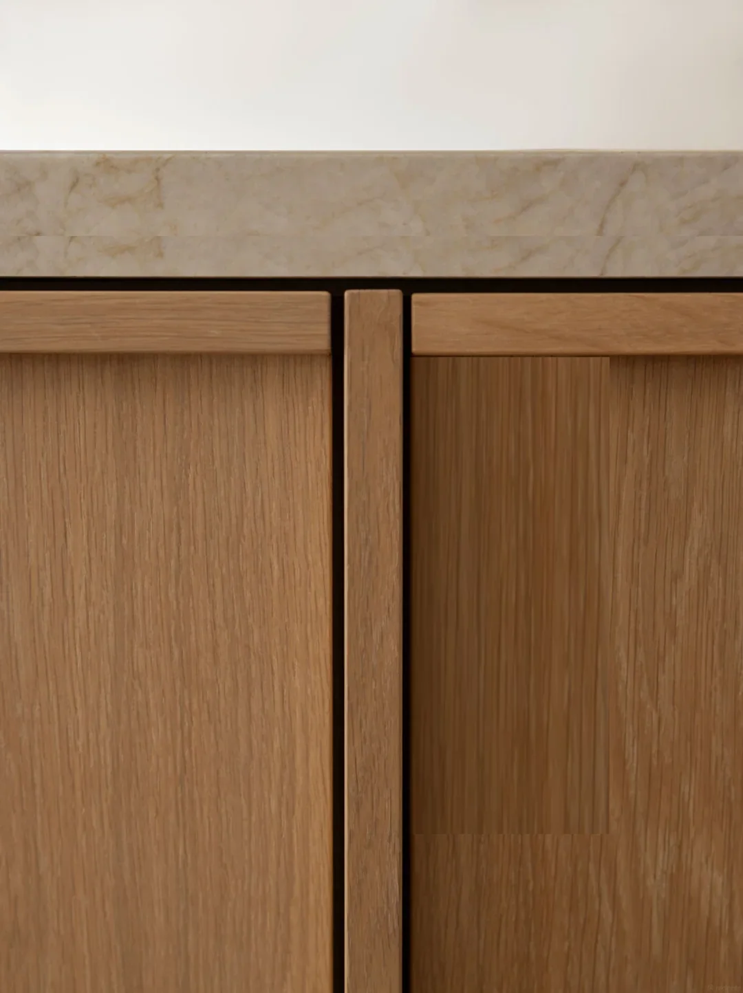 Veneer door meeting a stone counter with a shadow gap