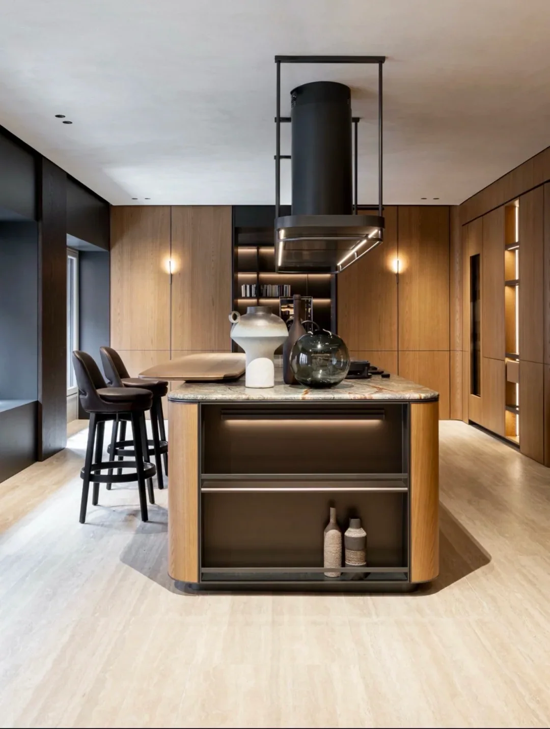 Walnut kitchen island with stone top and suspended hood