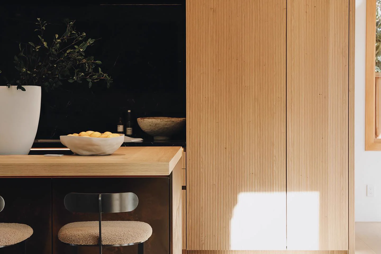 Fluted wood wall paneling with integrated lighting