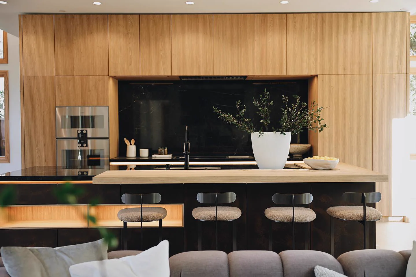 Custom oak kitchen with island and black marble backsplash
