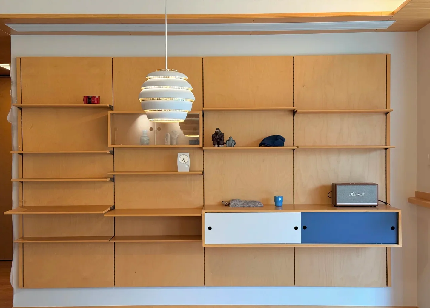 Open shelving wall with integrated LED lighting