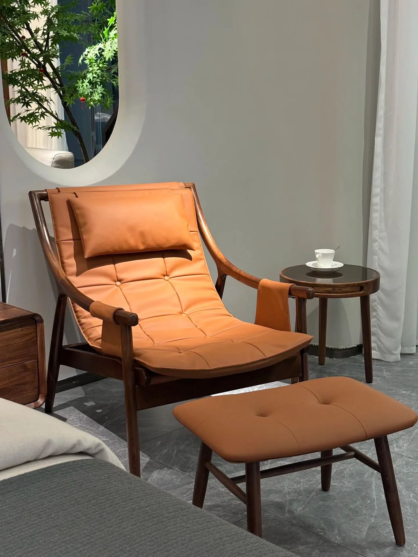 Tan leather lounge chair with matching ottoman
