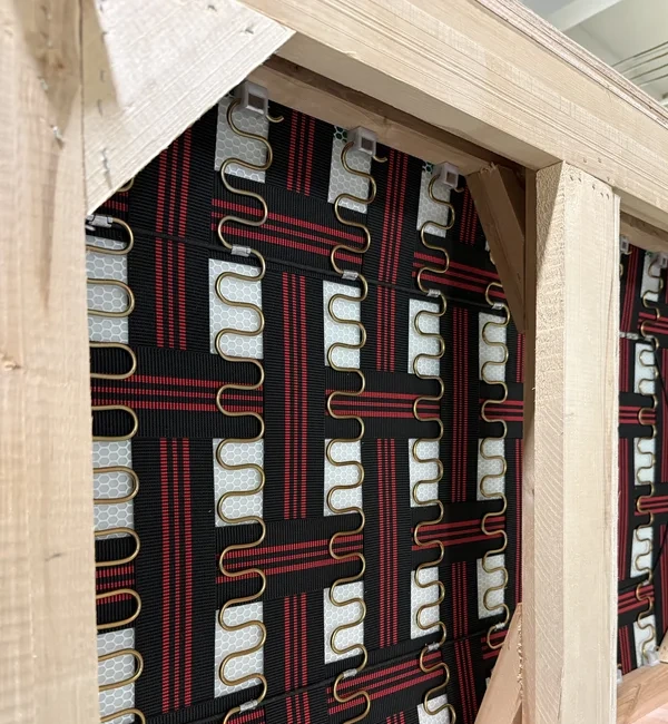 Close-up of webbing and sinuous spring support inside a sofa frame