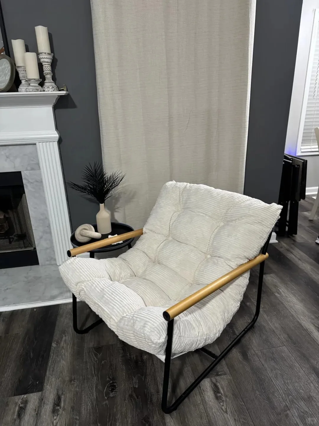 White cushioned lounge chair with exposed metal frame