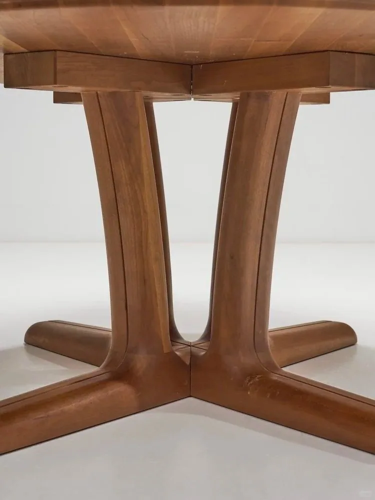 Close-up of a warm wood pedestal base showing construction detail.