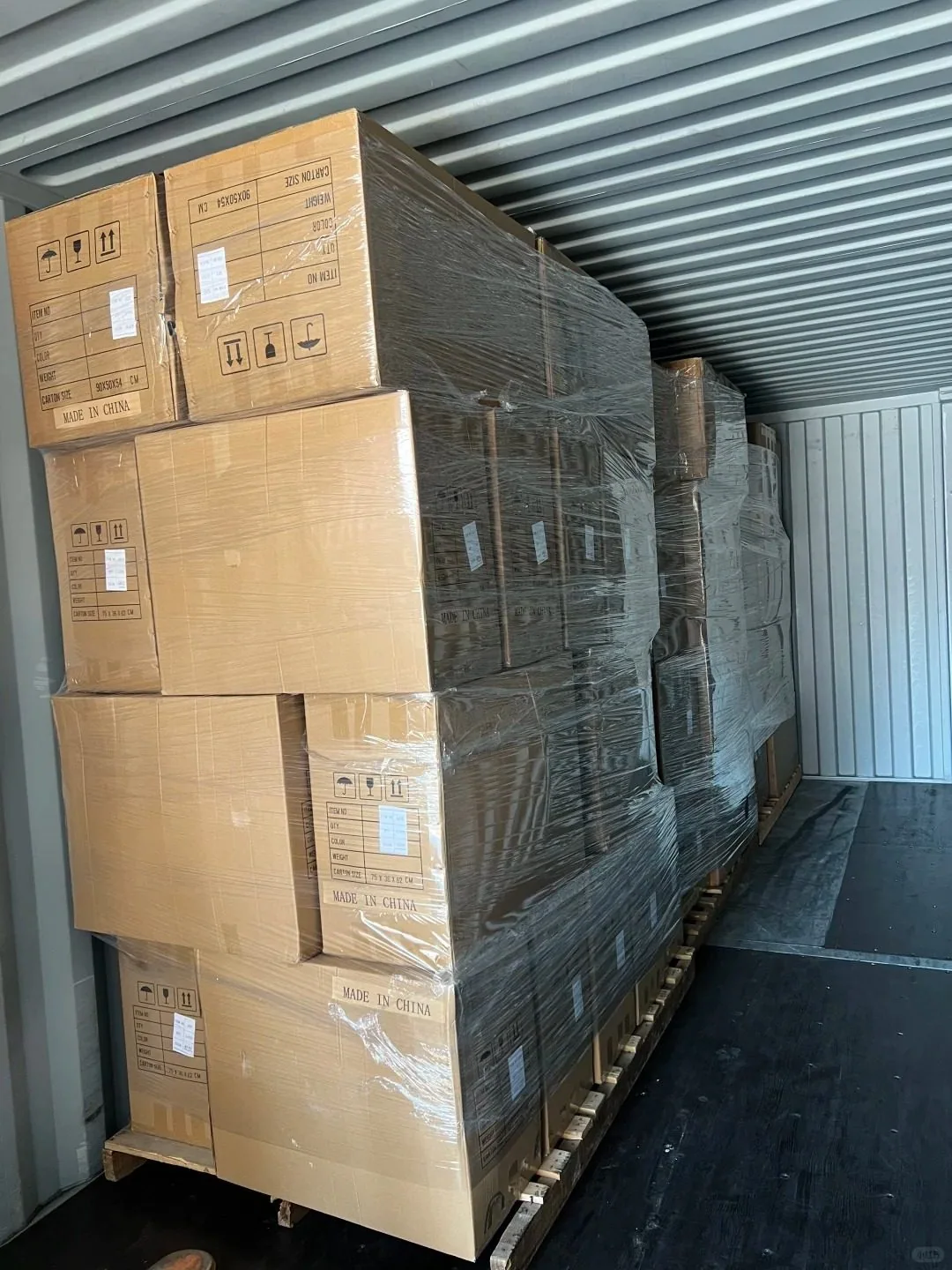 Furniture pieces being protected and loaded for shipping and delivery.