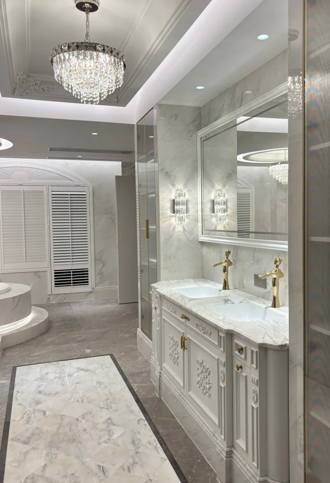 Custom bathroom vanity with marble surfaces, twin basins and tailored cabinetry