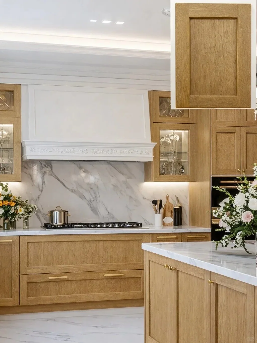 White oak Shaker cabinet fronts and light wood detailing in a finished kitchen