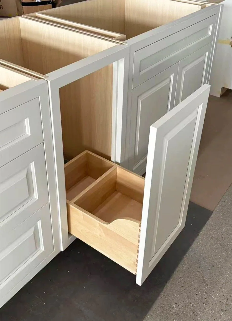 Custom inset cabinetry drawer pulled open showing wood drawer box and cabinet construction