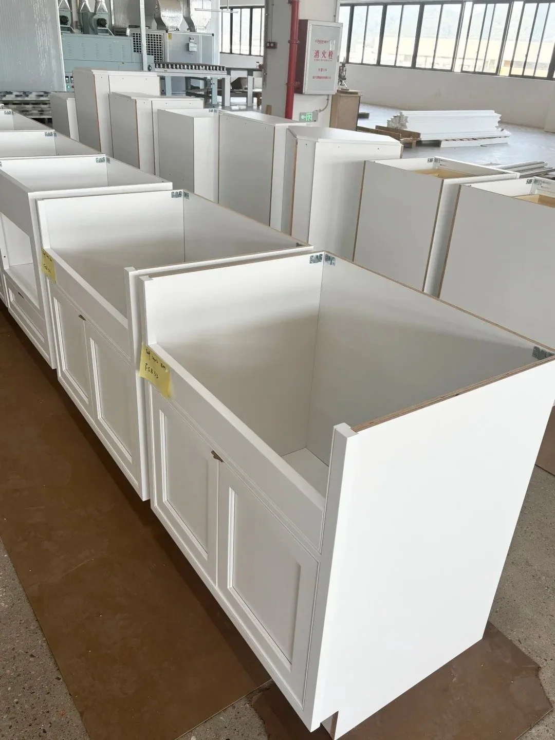 Rows of custom cabinet boxes during factory production