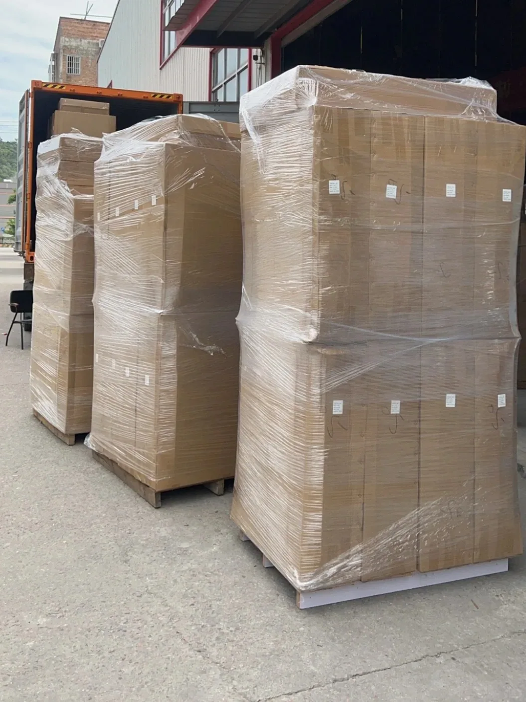 Custom cabinetry cartons grouped on pallets, wrapped and prepared for container loading