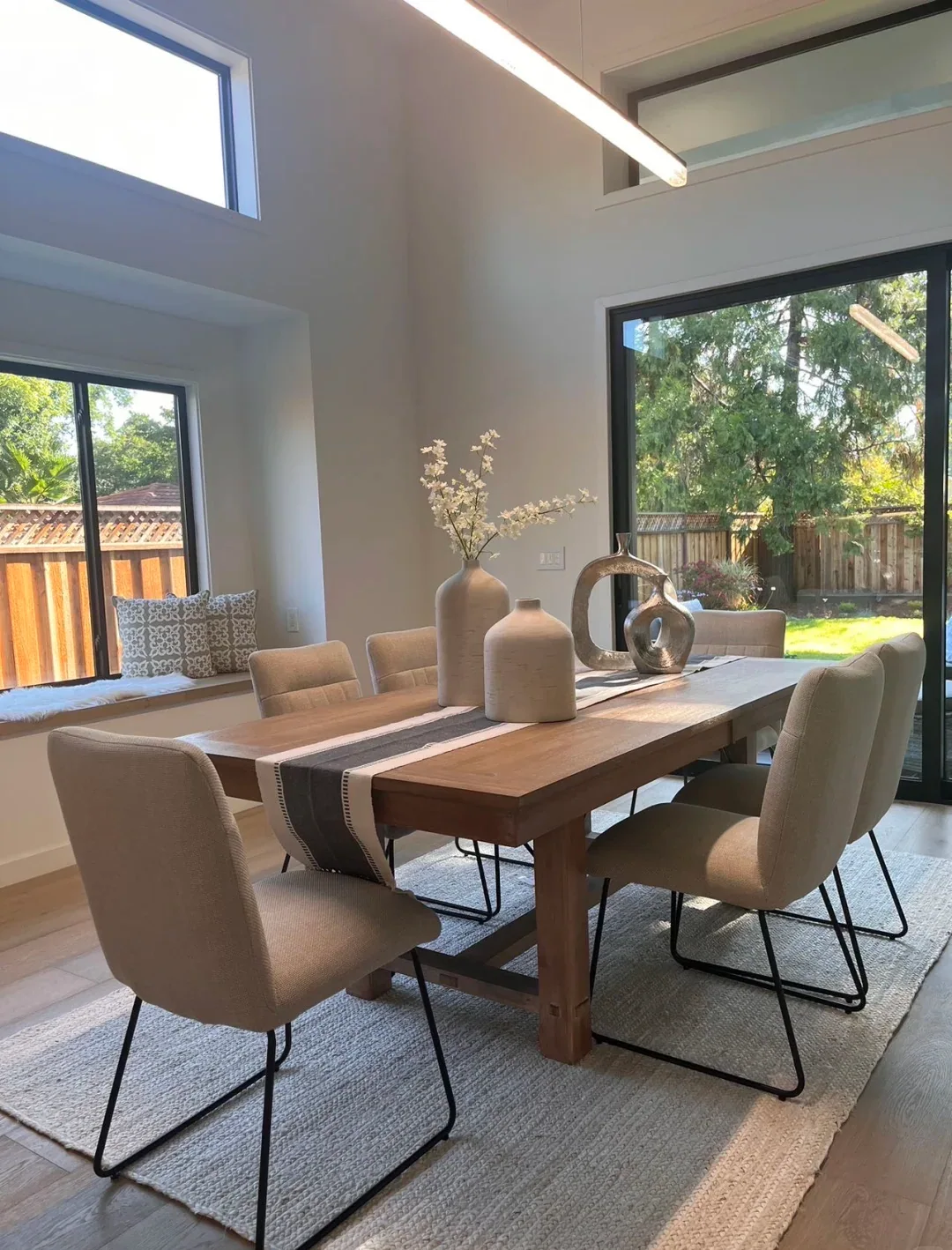 Rectangular wood dining table in bright dining room