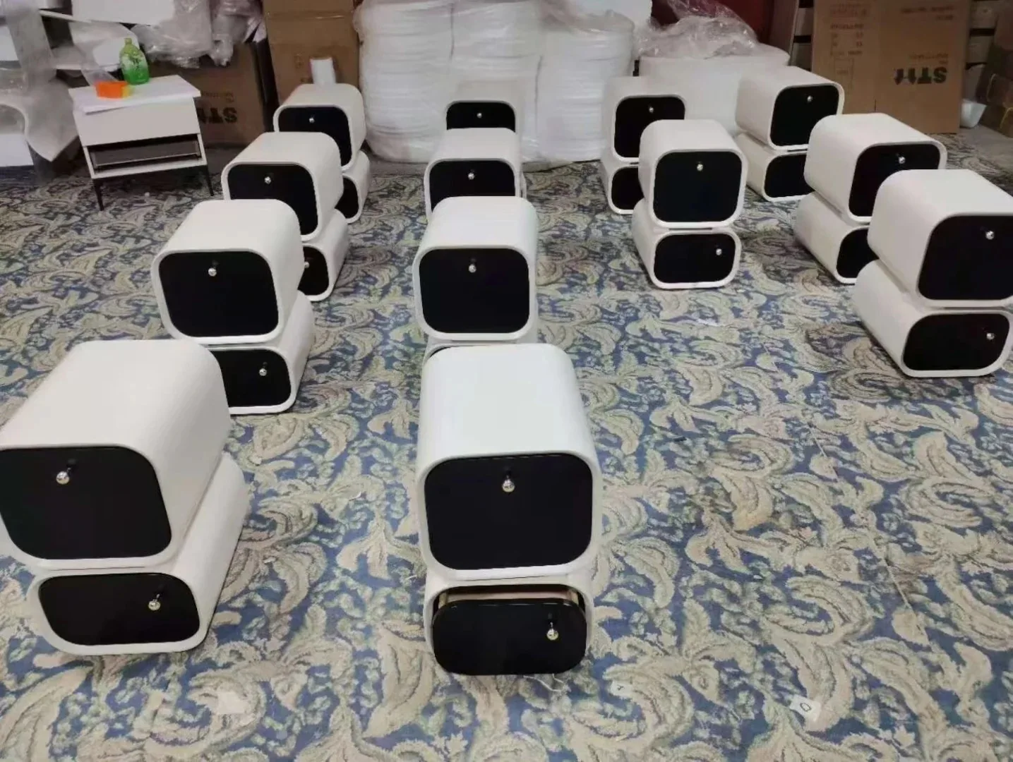 Factory display of white and black rounded nightstands