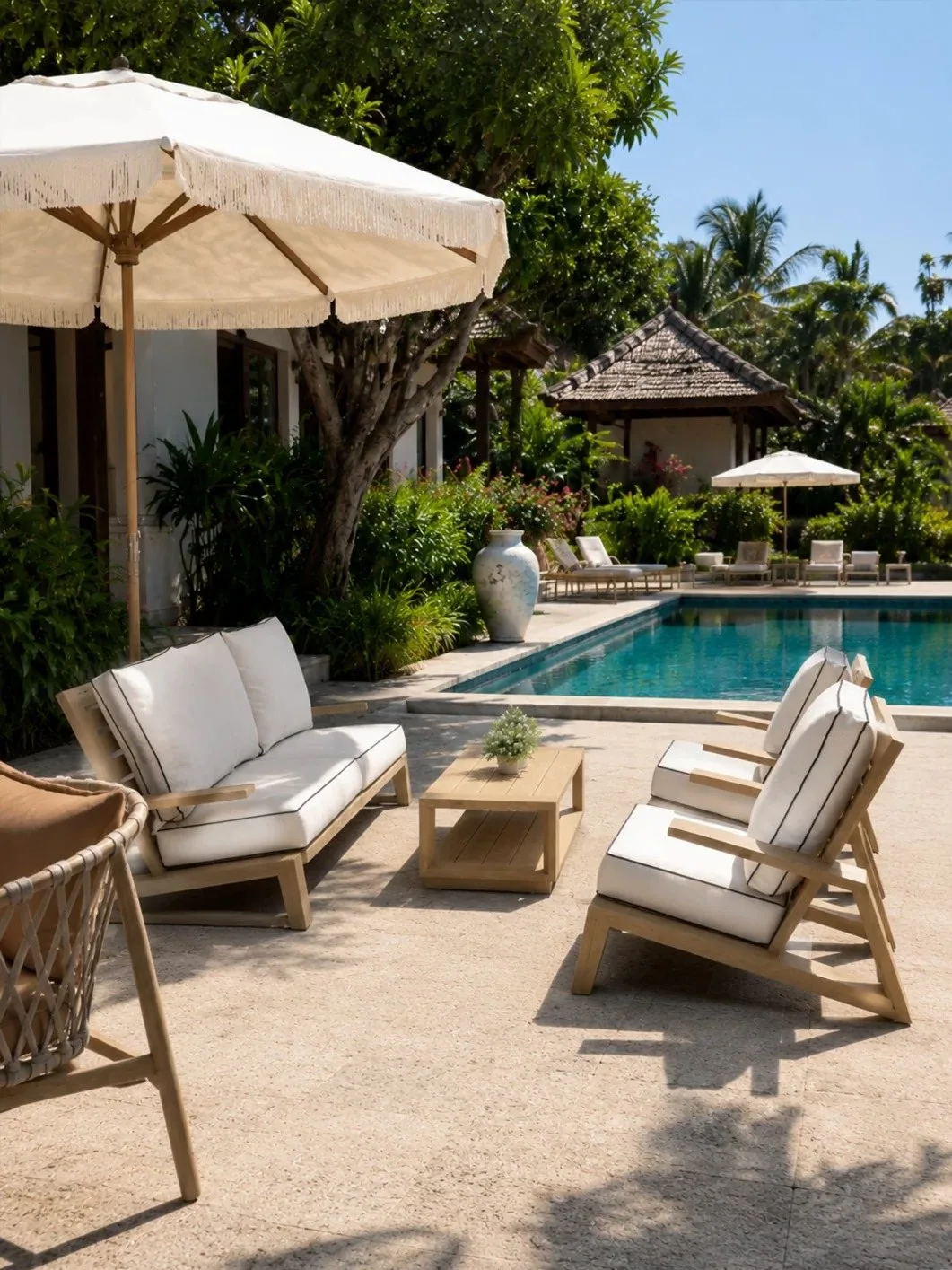 Outdoor lounge seating arranged beside a resort-style swimming pool