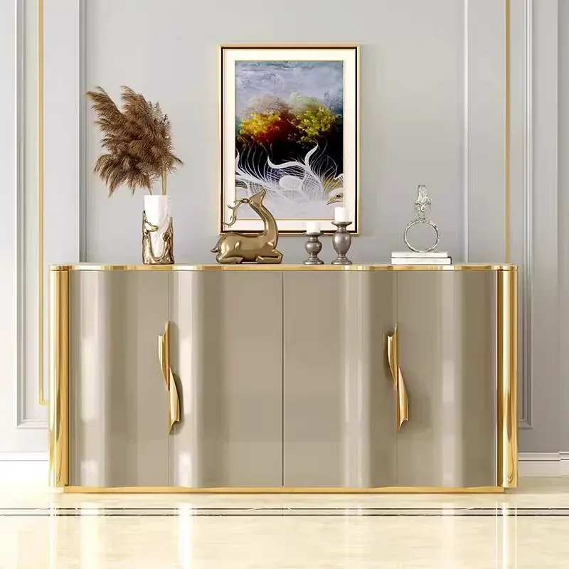 Sculptural beige sideboard with curved metallic edges and polished gold accents