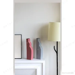 Abstract Curved Silhouette Ceramic Vases in White and Pink — in a room setting