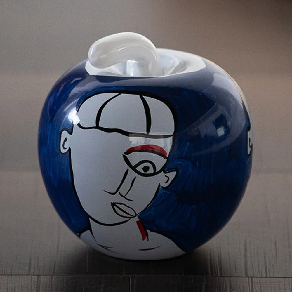 Hand-Painted Abstract Face Blue Glass Apple Ornament in blue — front view