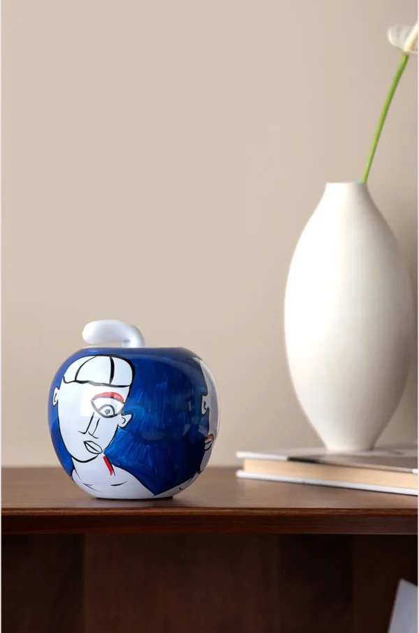 Hand-Painted Abstract Face Blue Glass Apple Ornament in blue — in a room setting