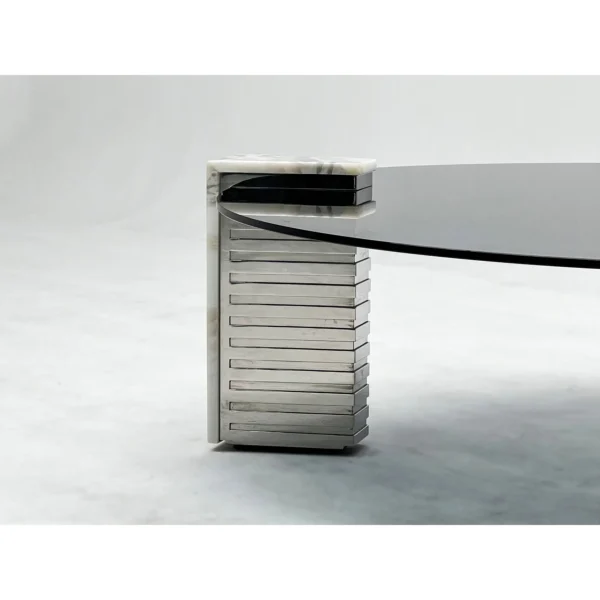 Round Glass Coffee Table on Marble and Chrome Column Base in black — in a room setting