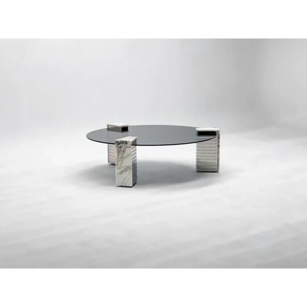 Round Glass Coffee Table on Marble and Chrome Column Base in black — in a room setting