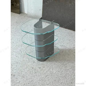 Three-Tier Glass Side Table on Curved Grey Metal Spine in slate — in a room setting