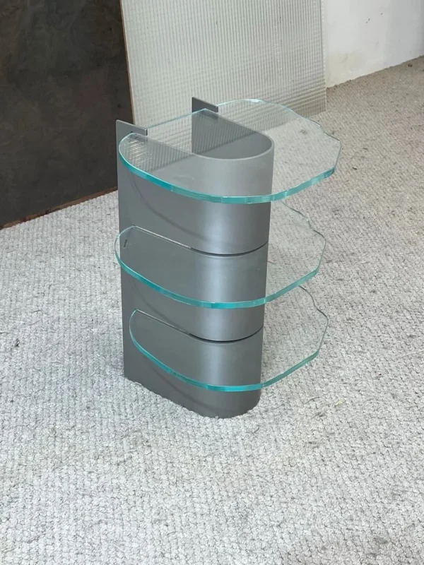 Three-Tier Glass Side Table on Curved Grey Metal Spine in slate — in a room setting