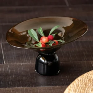 Amber and Black Hand-Made Footed Glass Fruit Bowl in clay — front view