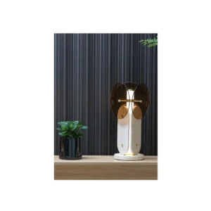 Amber Three-Wing Glass Table Lamp on Travertine Base in clay — in a room setting