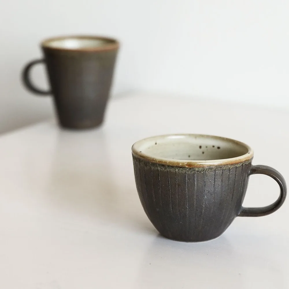 Artist Collaboration Black Glaze Ribbed Stoneware Mugs in black — front view