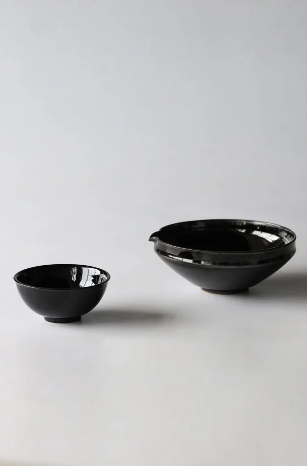 Artist Collaboration Black Gold Glaze Porcelain Bowls in black — in a room setting