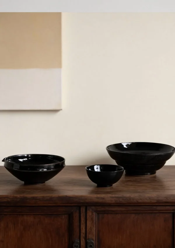 Artist Collaboration Black Gold Glaze Porcelain Bowls in black — in a room setting