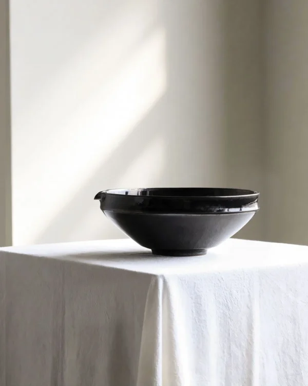 Artist Collaboration Black Gold Glaze Porcelain Bowls in black — in a room setting