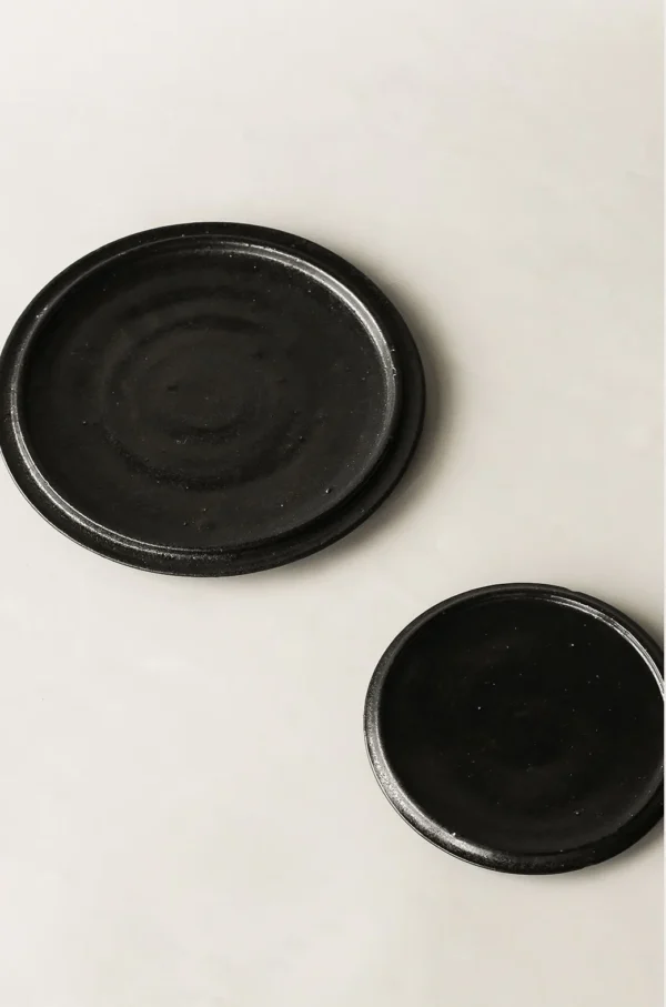 Handmade Black Swirl Stoneware Plates in black — in a room setting