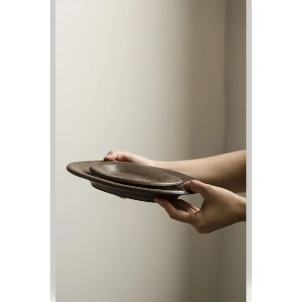 Artist Collaboration Brown Sand Glaze Oval Stoneware Plates in clay — in a room setting