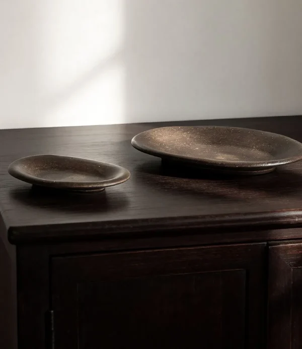 Artist Collaboration Brown Sand Glaze Oval Stoneware Plates in clay — in a room setting