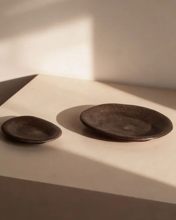 Artist Collaboration Brown Sand Glaze Oval Stoneware Plates in clay — in a room setting