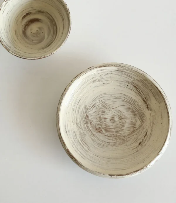 Artist Collaboration Brushed Ceramic Conical Bowl and Plate in ivory — in a room setting