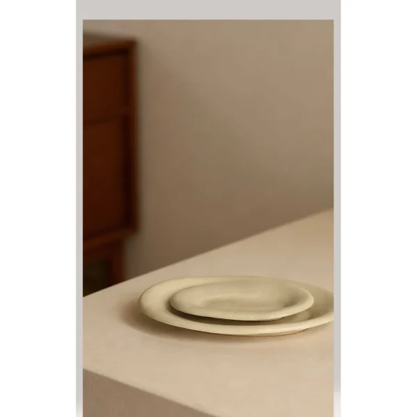 Artist Collaboration Oval Ceramic Plates in Pale Straw Glaze — in a room setting