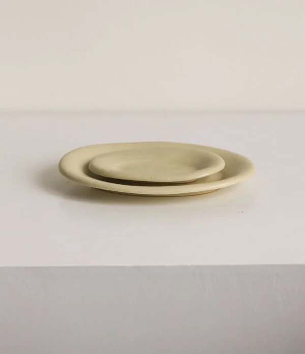 Artist Collaboration Oval Ceramic Plates in Pale Straw Glaze — in a room setting